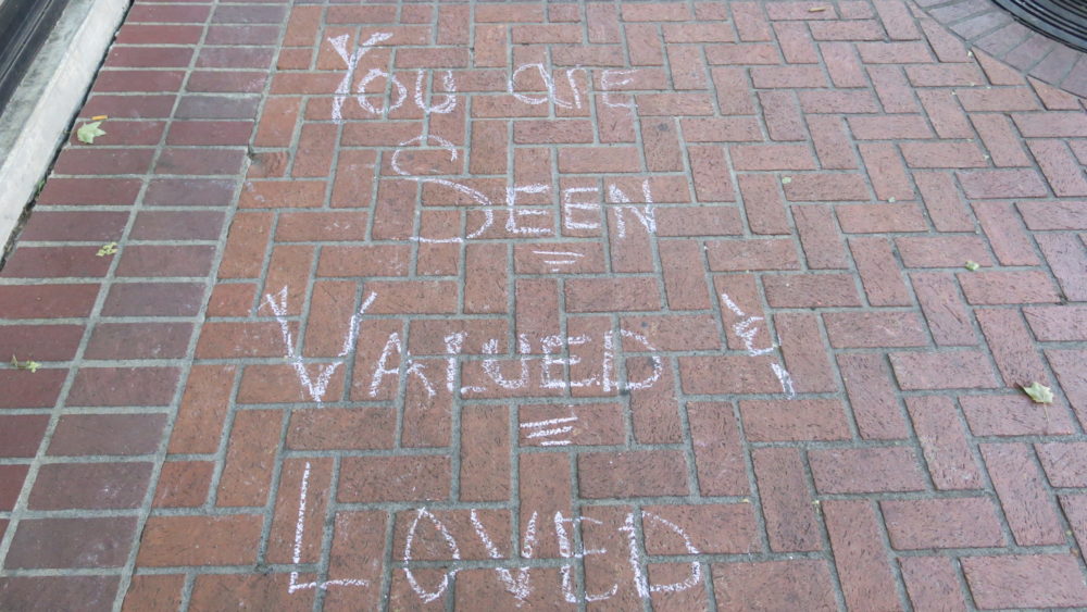 chalk writing on sidewalk with inspirational message